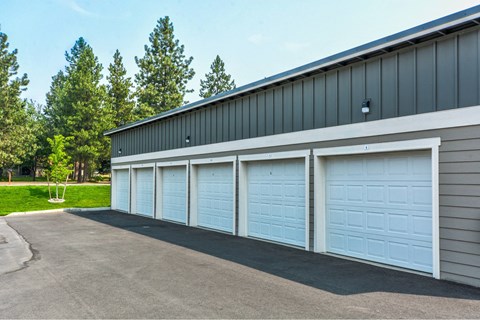 A building with four white garage doors.