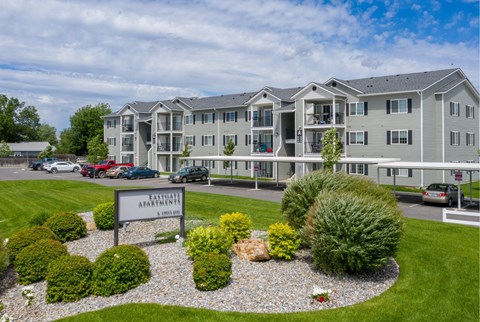 A building with the sign "Fairway Apartments" in front of it.