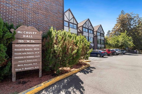 A sign in front of a building that says McCAULEY HALL.