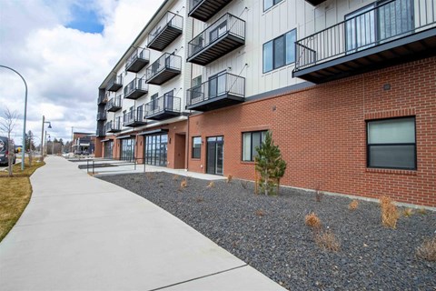 A long building with balconies on the second floor.