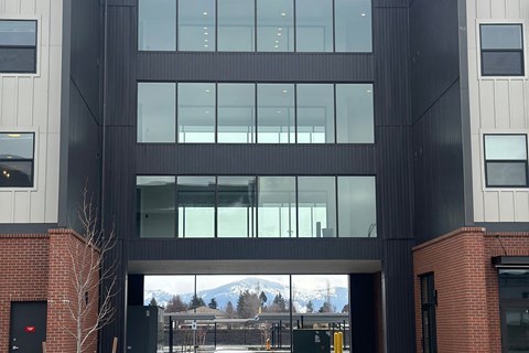 A modern building with a large glass window entrance.