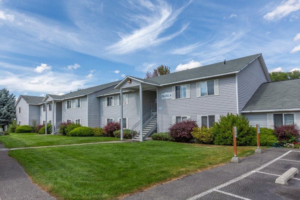 A row of apartments with a clear blue sky above them.
