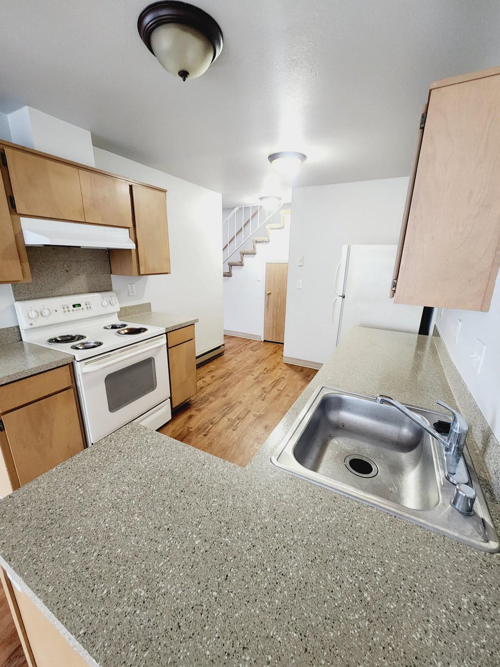 a kitchen with a sink and a stove and