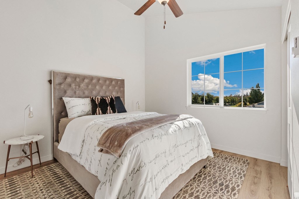 a bedroom with a bed and a window