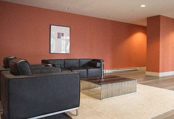 a living room with black couches and a coffee table