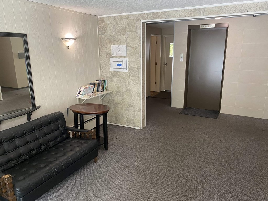 a small room with a couch and a small table