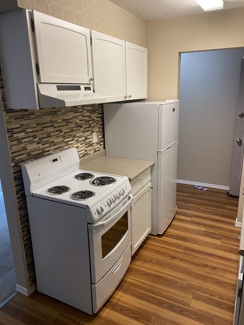 A kitchen with a stove and cabinets.