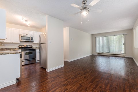 A kitchen with white cabinets and a stainless steel refrigerator.