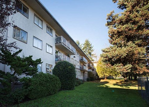 a large grassy area in front of an apartment building
