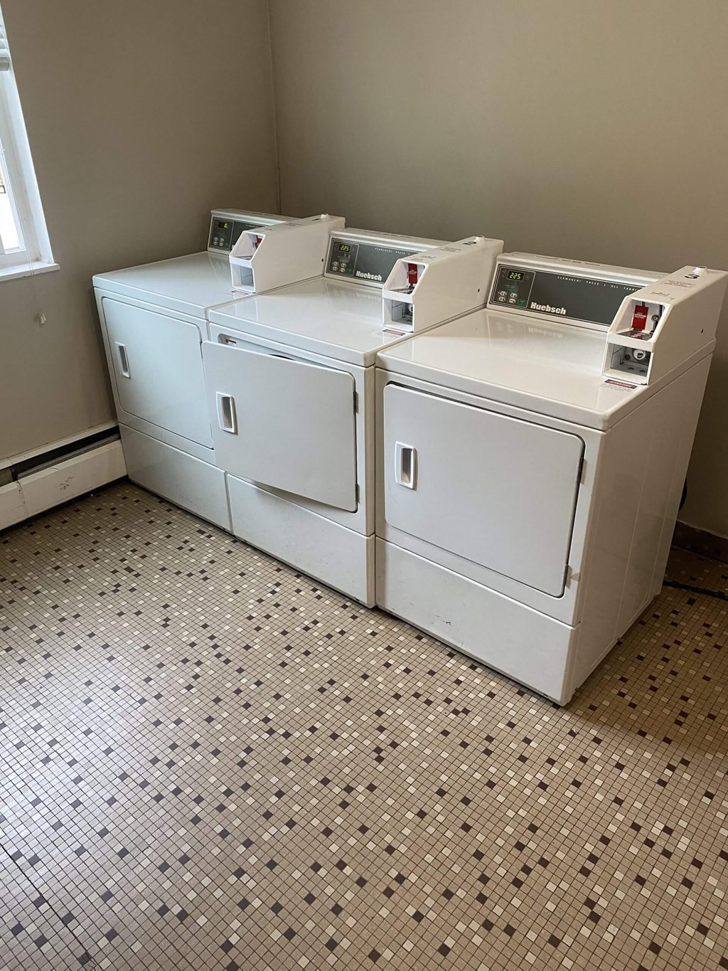 two washers and two dryers in a laundry room