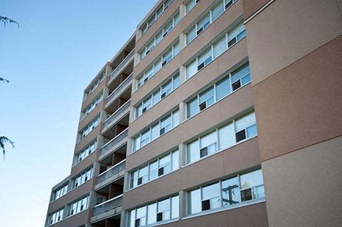 A tall building with many windows and balconies.