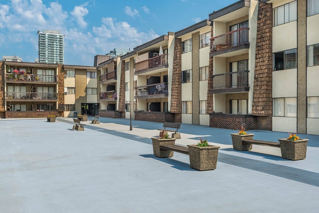 A sunny day at a courtyard surrounded by residential buildings.