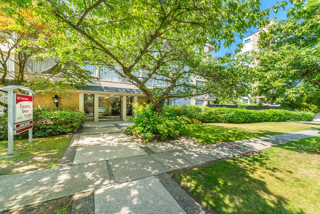 A building entrance with a sign that says "Welcome to Hillcrest Apartments".