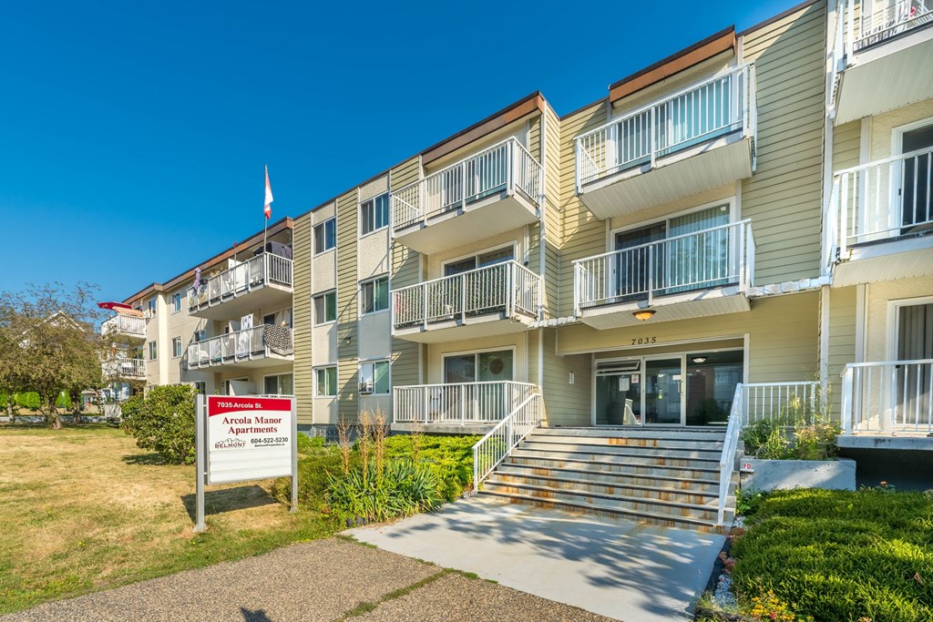 Apartment building with a sign in front that says "Apartments for sale".