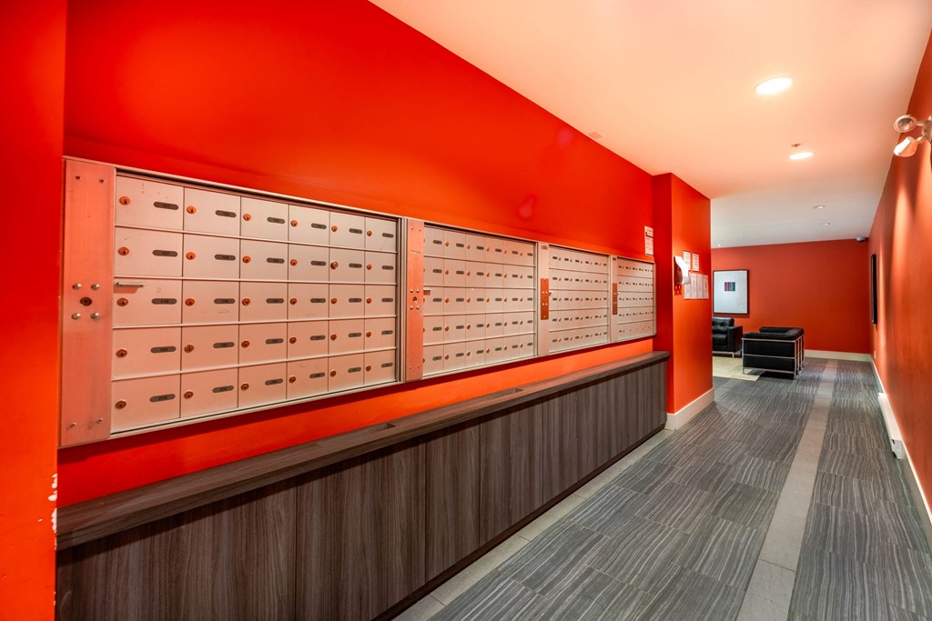 A row of mailboxes are lined up on a wall.