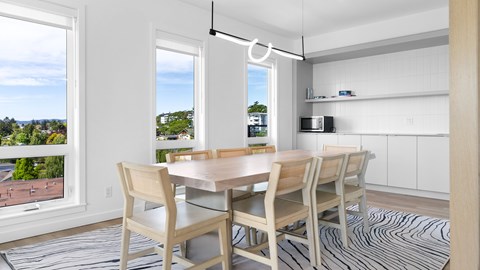 A dining room with a table and chairs.