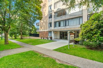 A building with a green lawn in front of it.