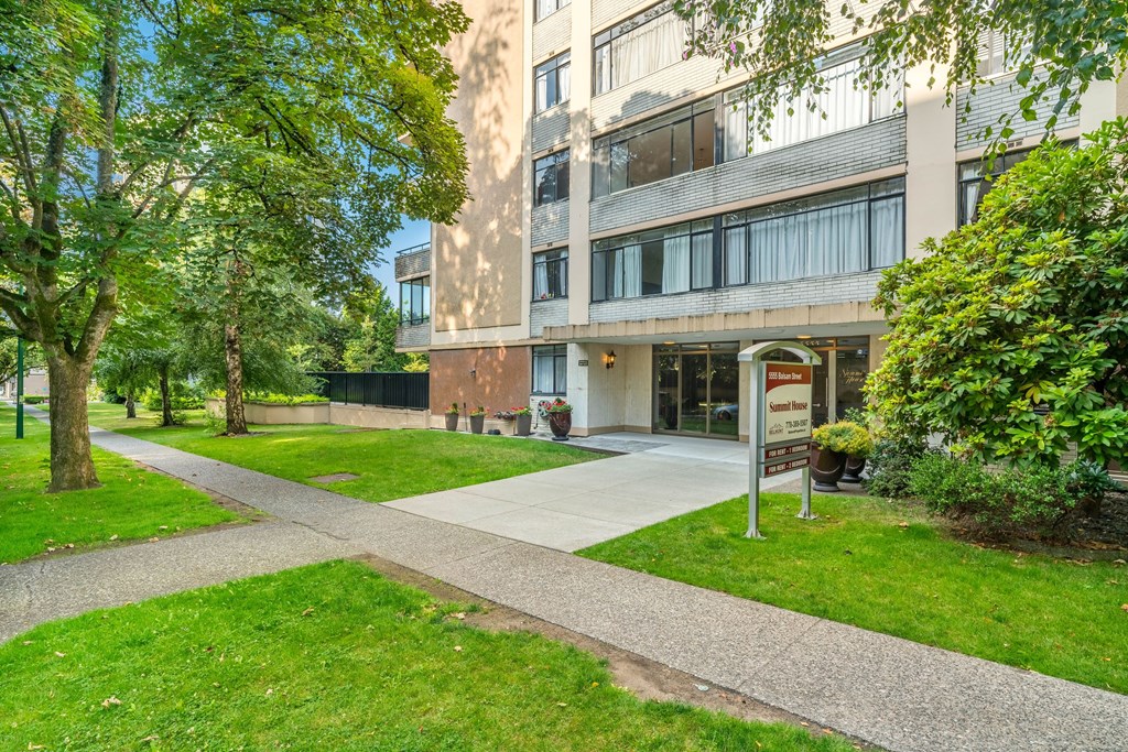 A building with a green lawn in front of it.