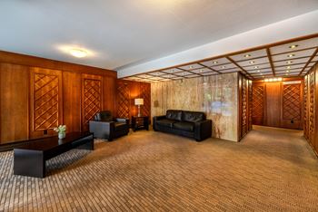 A room with wooden walls and a carpeted floor.