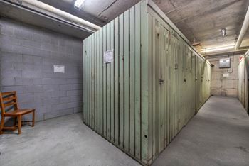 A room with a wooden chair and a green wall.