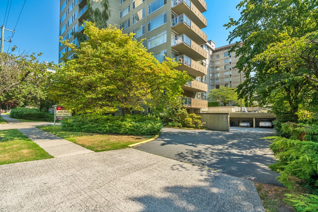 A residential area with apartment buildings and a tree with yellow leaves.