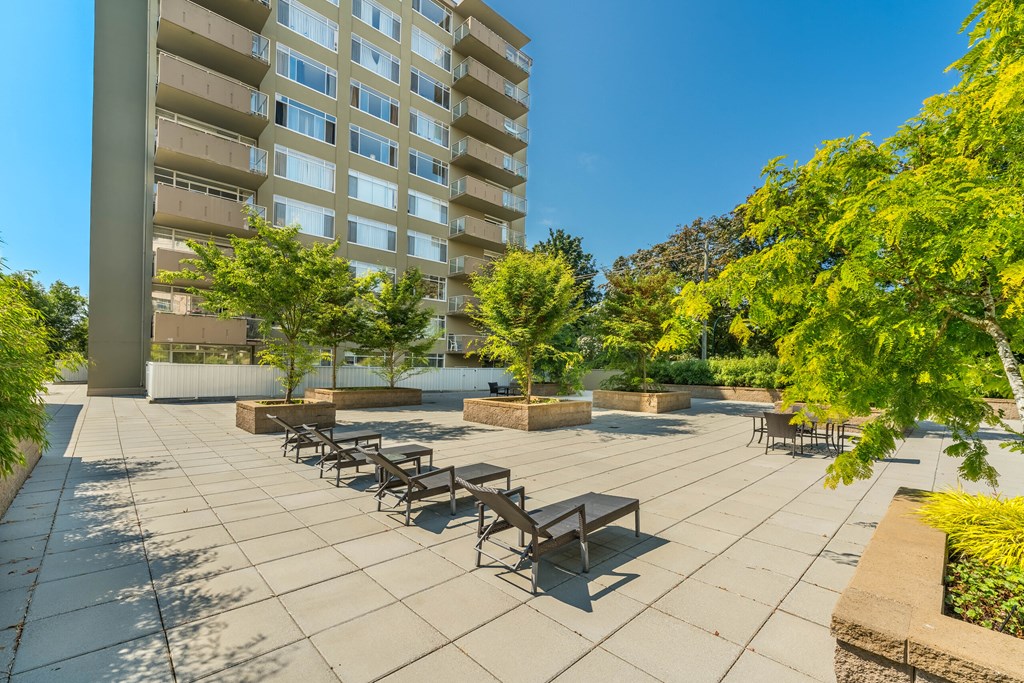 A sunny day at the outdoor seating area of a modern apartment complex.