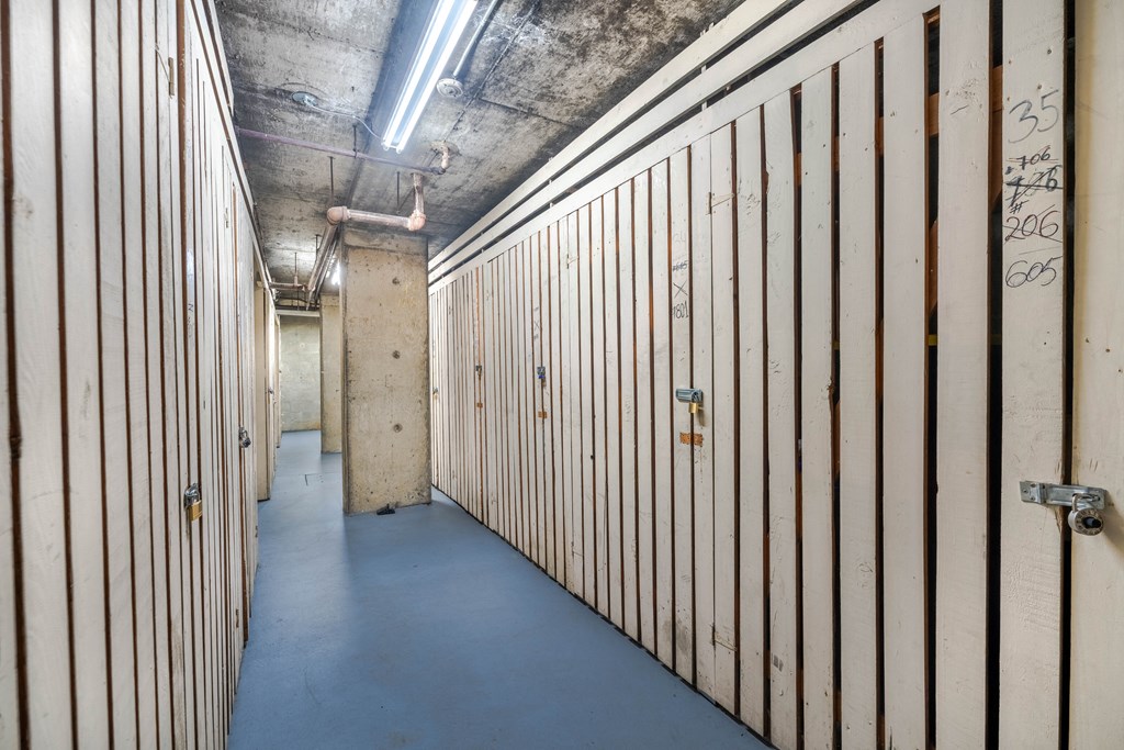 A long hallway with wooden doors on both sides.