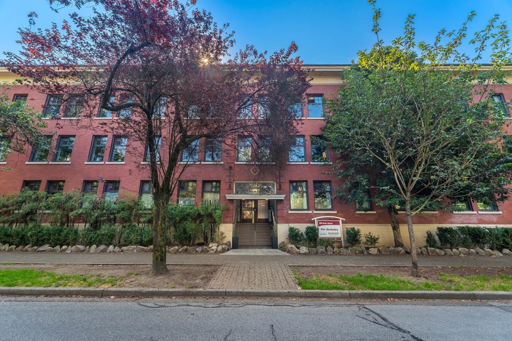 A red building with a tree in front of it.
