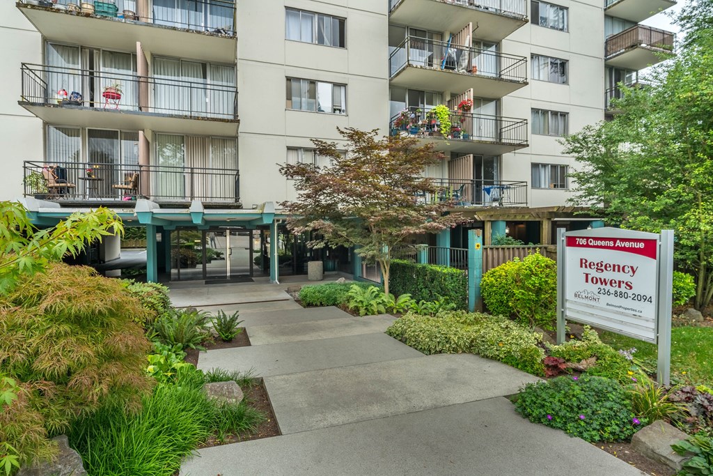 A building with a sign that says "Regency Towers" in front of it.