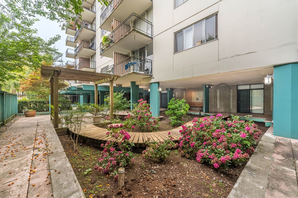 A building with a garden in front of it.