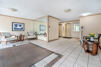 A living room with a brown rug and a wooden coffee table.