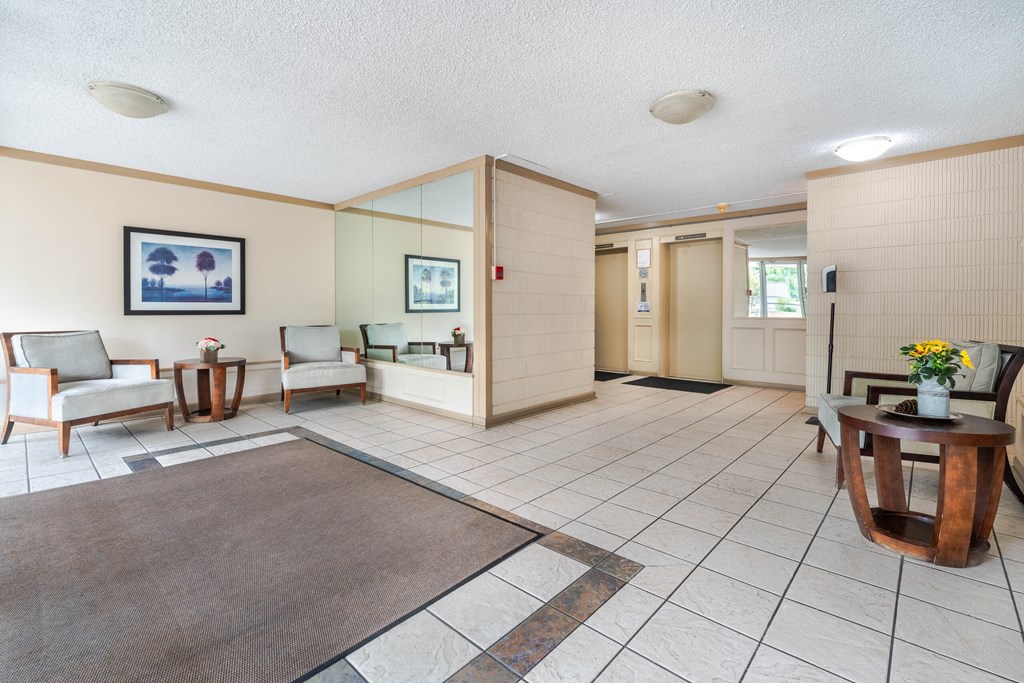 A living room with a brown rug and a wooden coffee table.