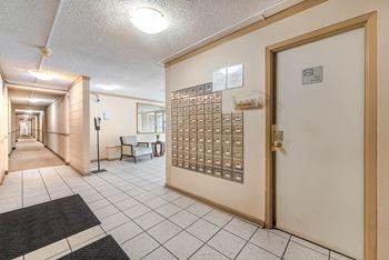 A hallway with a mailbox on the right side.