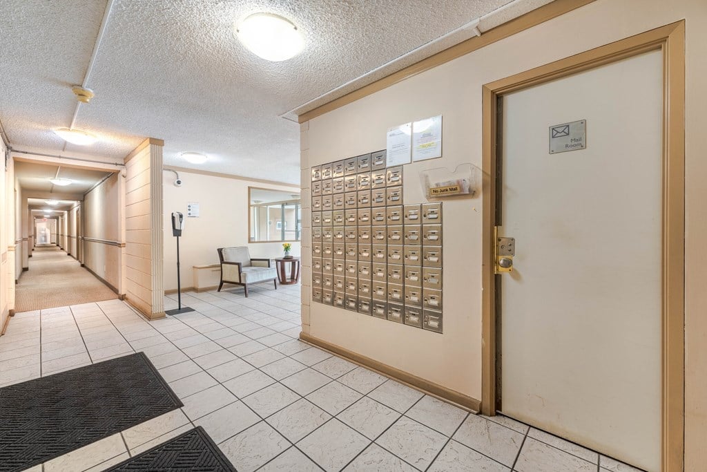 A hallway with a mailbox on the right side.
