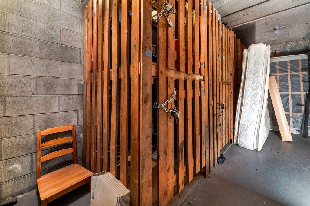 A room under construction with wooden studs and a chair.