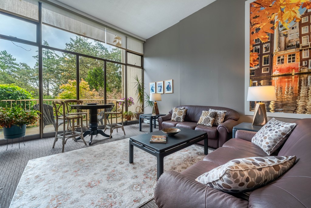 A living room with a brown leather couch and a coffee table.