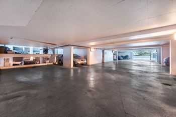 A spacious garage with a concrete floor and a white ceiling.