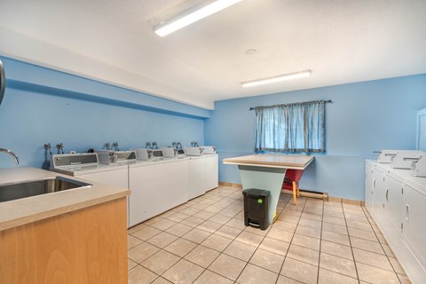 A kitchen with blue walls and white appliances.