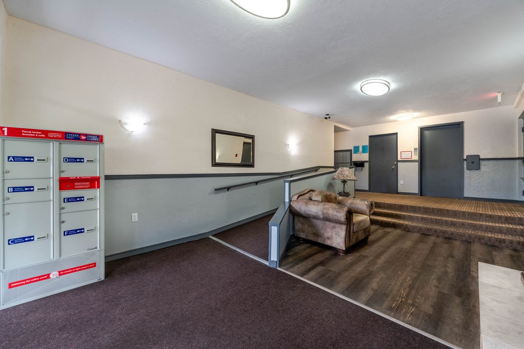 A room with a couch and a wall with a mirror.