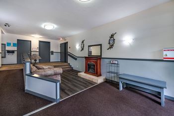 A room with a fireplace and a bench.