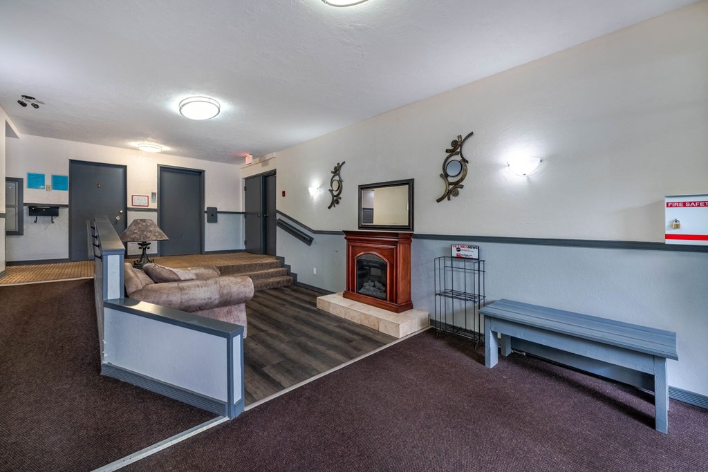 A room with a fireplace and a bench.