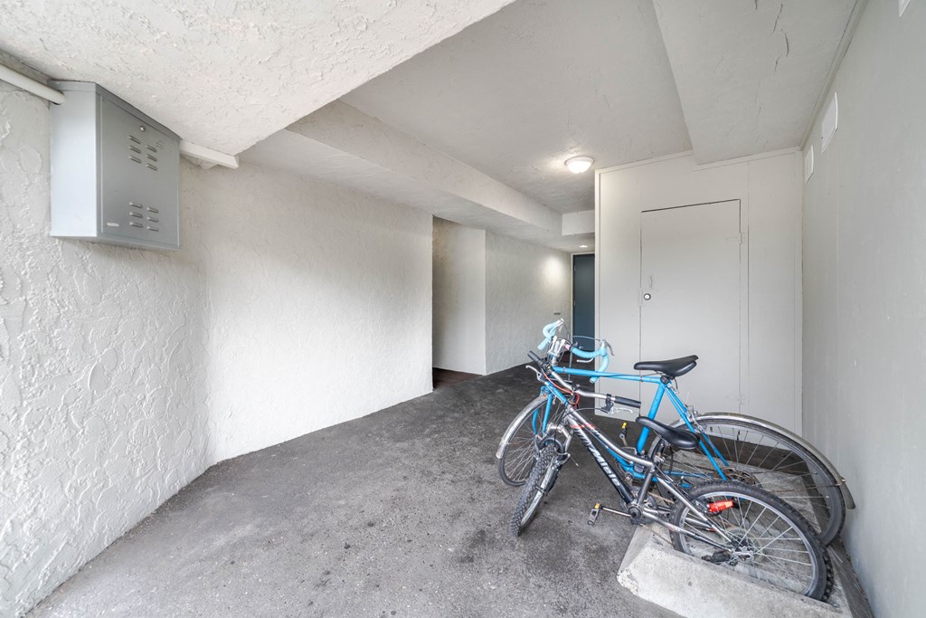A blue bicycle is parked in a concrete nook.