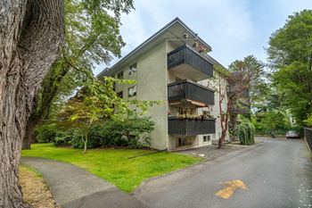 Apartment building with a yellow arrow on the street.