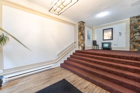 A living room with a staircase leading to the second floor.