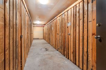 A long hallway with wooden walls under construction.