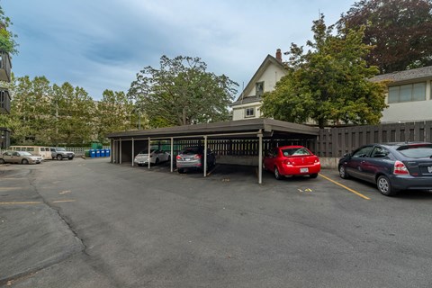 A parking lot with cars and a building in the background.