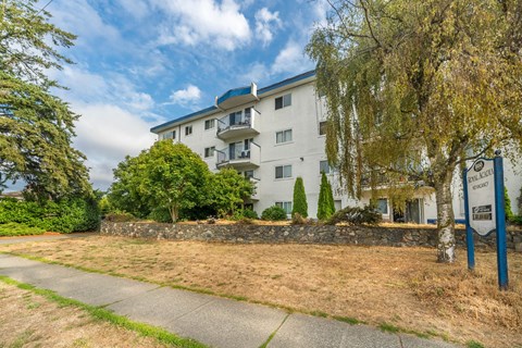 A building with a sign that says "The Ridge" in front of it.