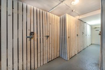 A long hallway with wooden walls and doors.