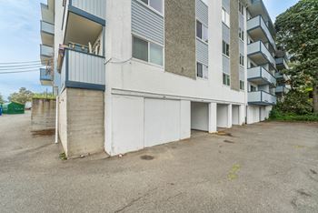 A large white building with a balcony on the second floor.