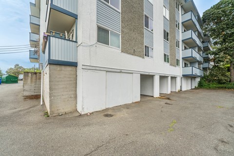 A large white building with a balcony on the second floor.
